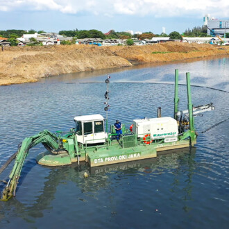 Watermaster dredging accumulated silt from Jakarta's water bodies to improve water flow and prevent flooding in Indonesia.