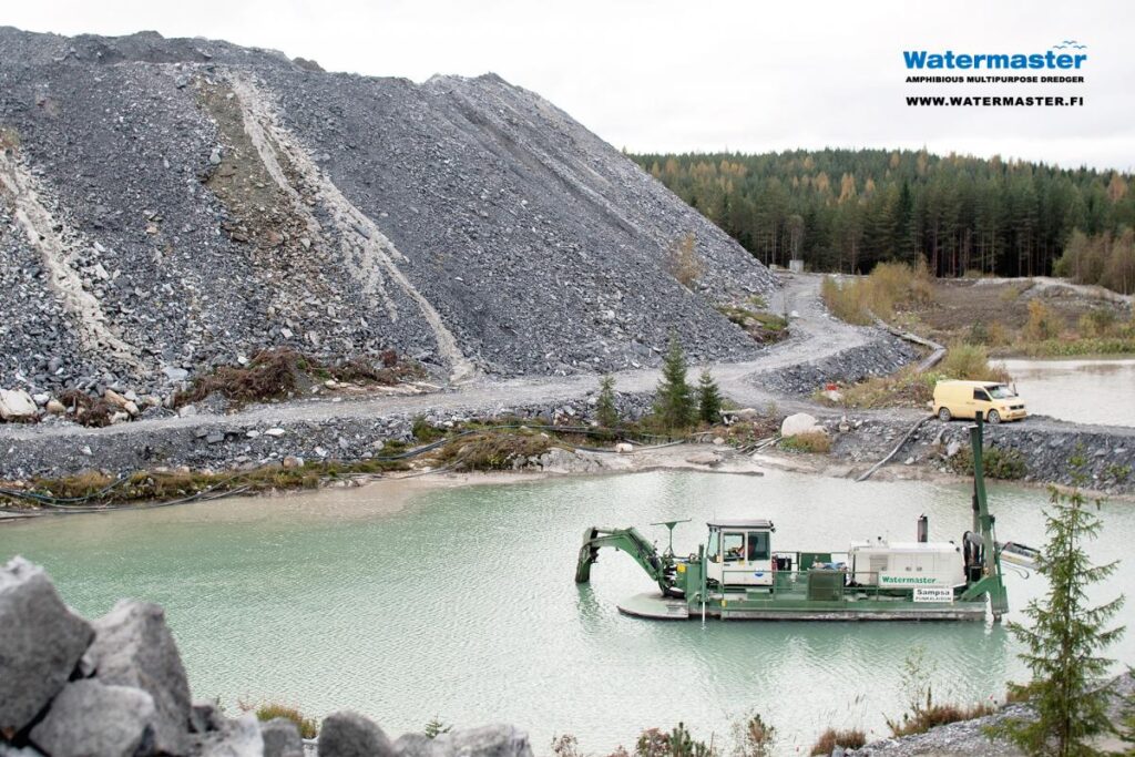 Amphibious Watermaster dredger cleaning a process water pond at a gold mine