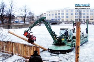 Multipurpose Watermaster dredger Installing timber piles