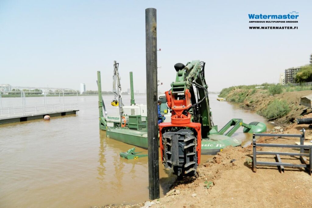 Watermaster dredger pile driving to build docks for tourist boats