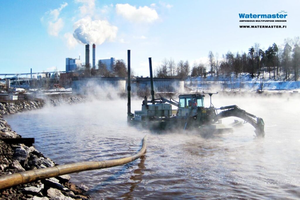 Watermaster dredger cleaning a paper mill wastewater treatment pond by suction dredging