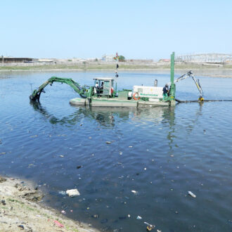 Watermaster cleaning a river by suction dredging in Accra, Ghana.