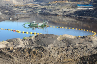 Watermaster cleaning an old industrial waste pond in Germany