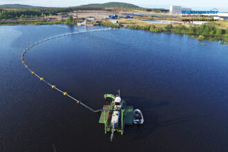 Watermaster Cleaning the waste lake of old pulp mill in the Finnish Lapland, Finland