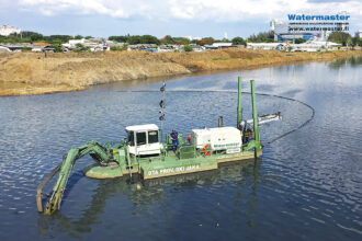 Dredging accumulated silt from Jakarta’s water bodies to improve water flow and prevent flooding in Indonesia