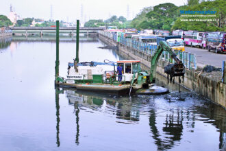 Watermaster removing sludge, trash, and invasive vegetation in India