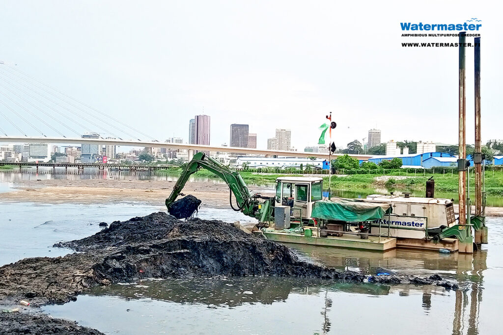 Waterway cleanup, removing silt and trash with Watermaster to improve water flow and prevent floods in Ivory Coast
