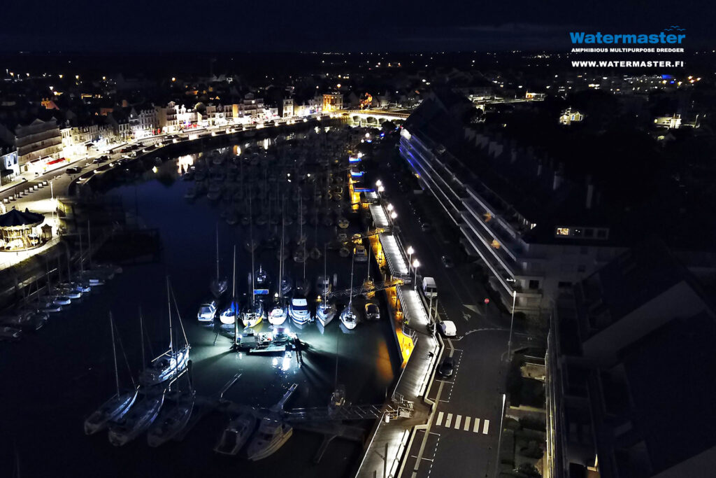 Watermaster desilting a marina to secure safe passage for boats in France