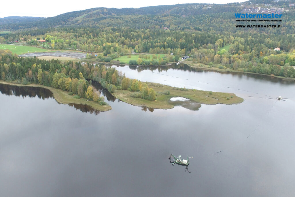 Watermaster cleans a lake by dredging out polluted sediments into dewatering tubes in Norway