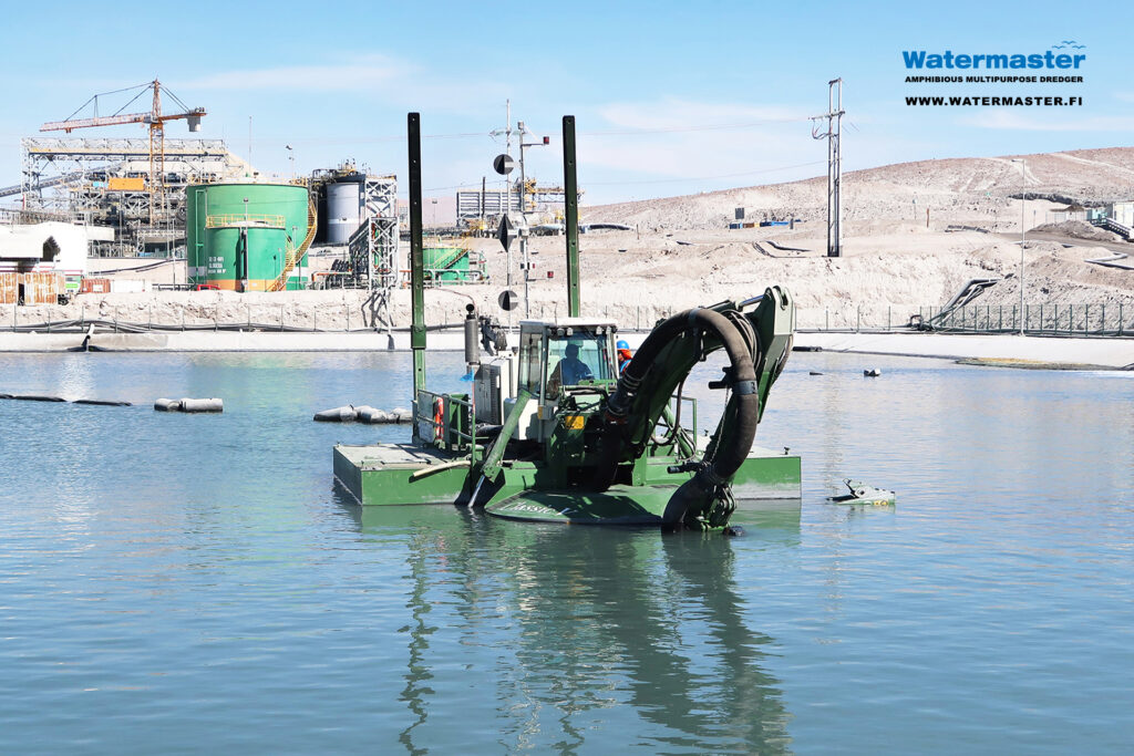 Watermaster recovering valuable materials from a process water pond in a copper mine in Chile