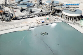 Watermaster recovers valuable materials from a process water pond in a copper mine in Chile