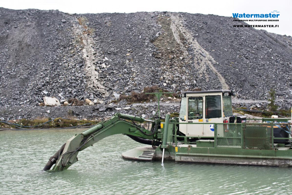 Watermaster dredger pumping sediments from a process water pond at a gold mine